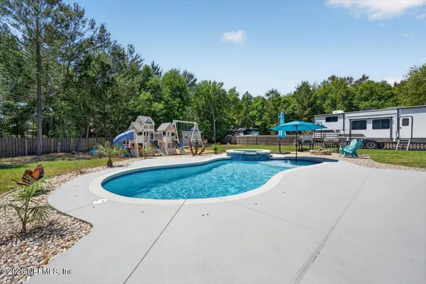 an aerial view of a house with yard swimming pool and outdoor seating