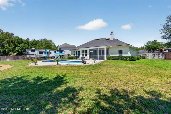 a aerial view of a house with yard swimming pool and outdoor seating
