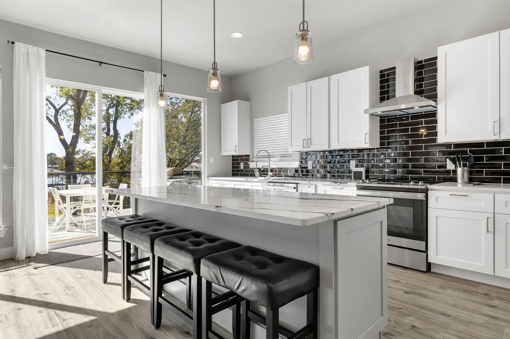 6811 Briar Road Azle, TX 76020 - Photo 17 of 34 a kitchen with granite countertop a sink appliances and cabinets