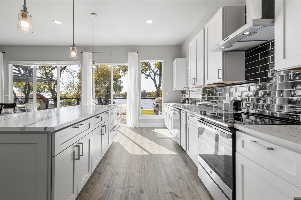6811 Briar Road Azle, TX 76020 - Photo 18 of 34 a kitchen with stainless steel appliances granite countertop a lot of counter space and wooden floors