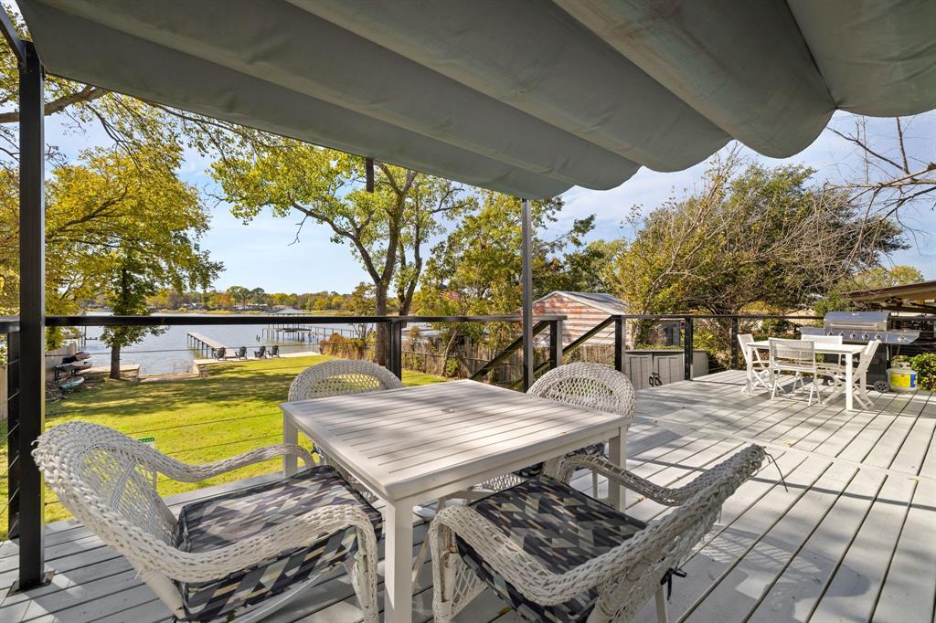 6811 Briar Road Azle, TX 76020 - Photo 26 of 34 a view of a patio with couches table and chairs under an umbrella with a small yard