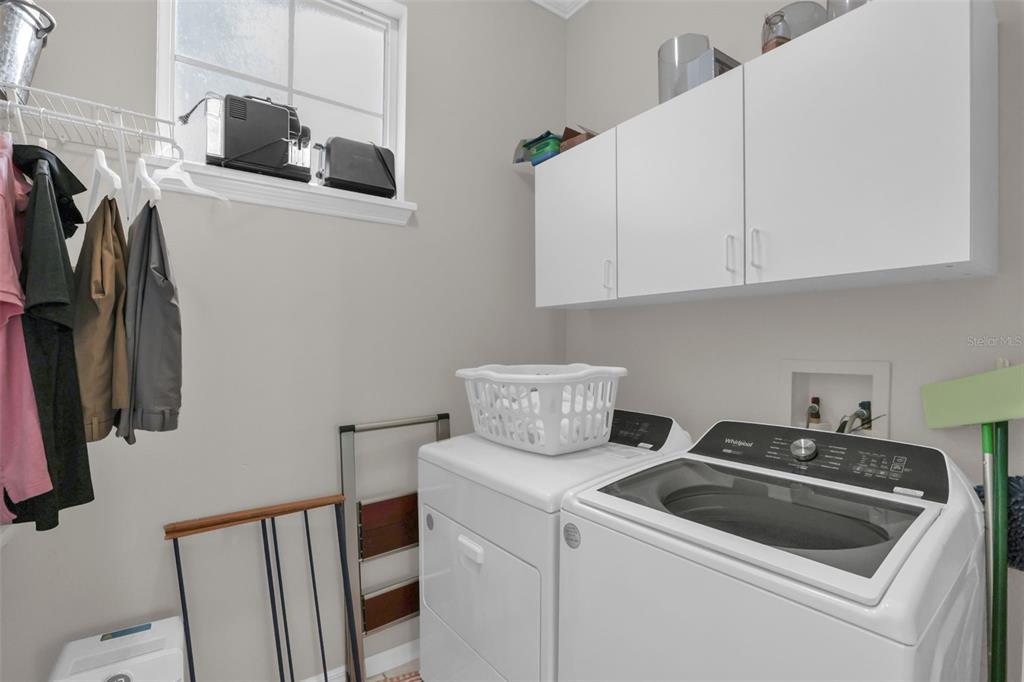2165 Ridgewood Street Orlando, FL 32803 - Photo 16 of 37 a view of storage and utility room with washer and dryer