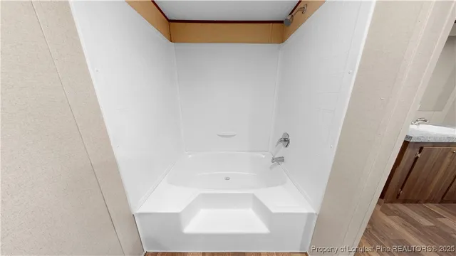 a view of a livingroom with wooden floor and stairs