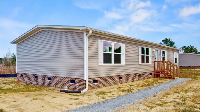 a view of a house with a wooden fence