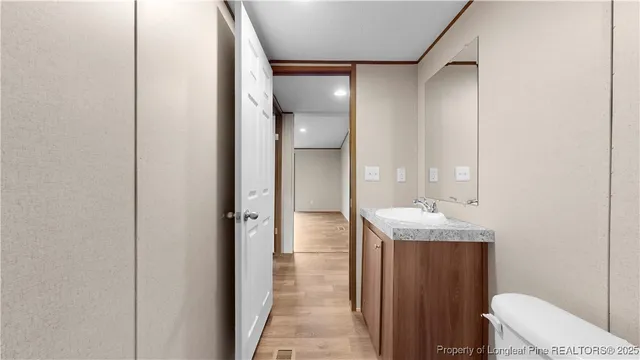 a bathroom with a granite countertop sink a toilet and shower