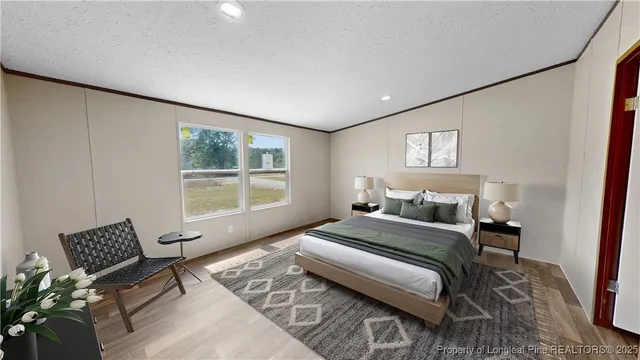 a bedroom with a bed lamp and a large window