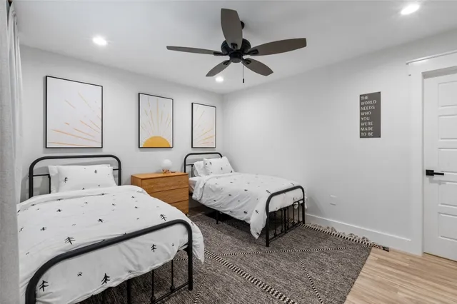 a bedroom with 2 bed and a window