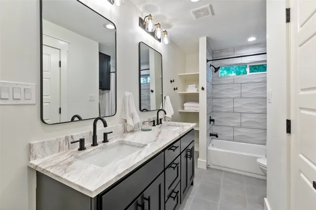 a bathroom with a tub sink and mirror