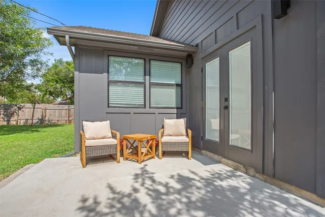 a backyard of a house with table and chairs