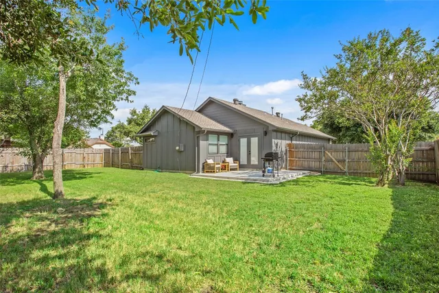 a view of a house with backyard and a sitting area