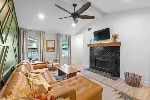 a living room with furniture and a fireplace