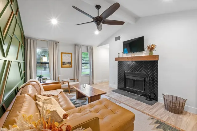 a living room with furniture and a fireplace