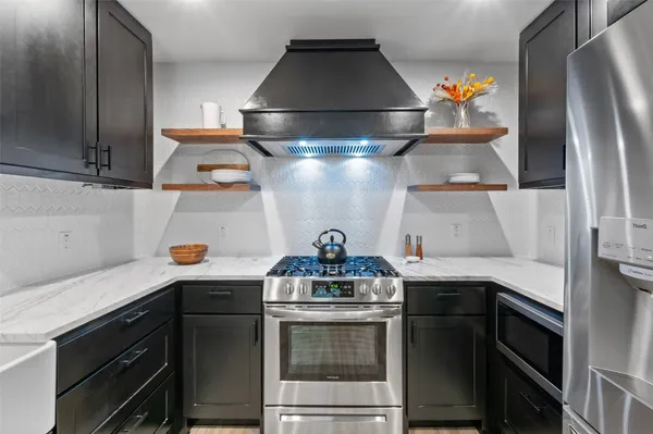 a kitchen with a stove and a refrigerator