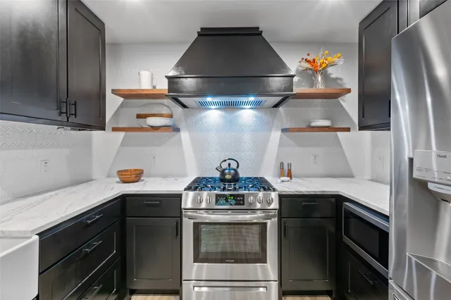 a kitchen with a stove and a refrigerator