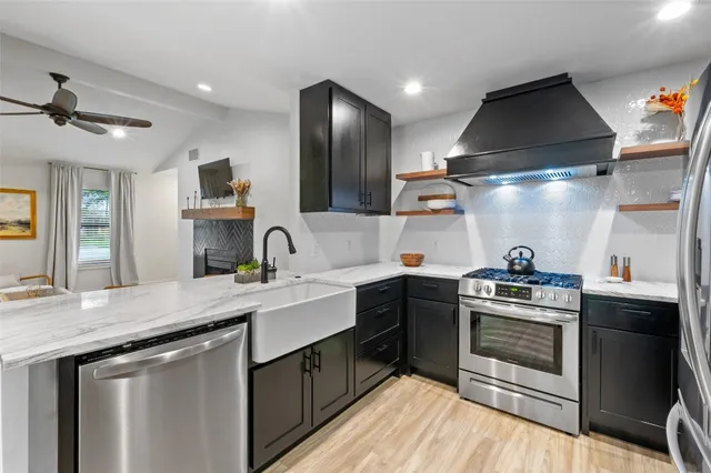 a kitchen with a sink stove and cabinets