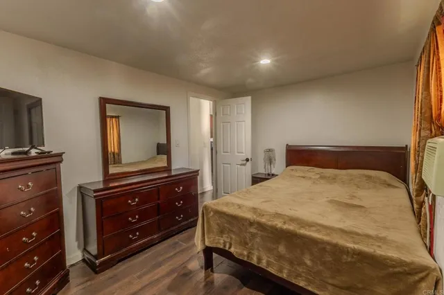 a bedroom with a bed and a dresser