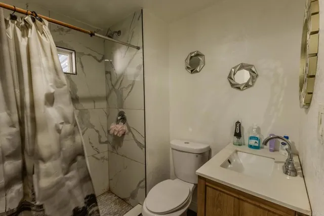 a bathroom with a sink toilet and shower