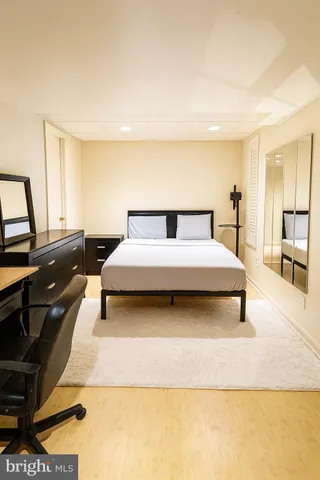 a living room with a bed furniture and a flat screen tv