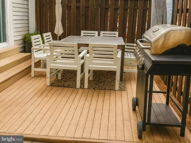 a view of a balcony with furniture and wooden floor