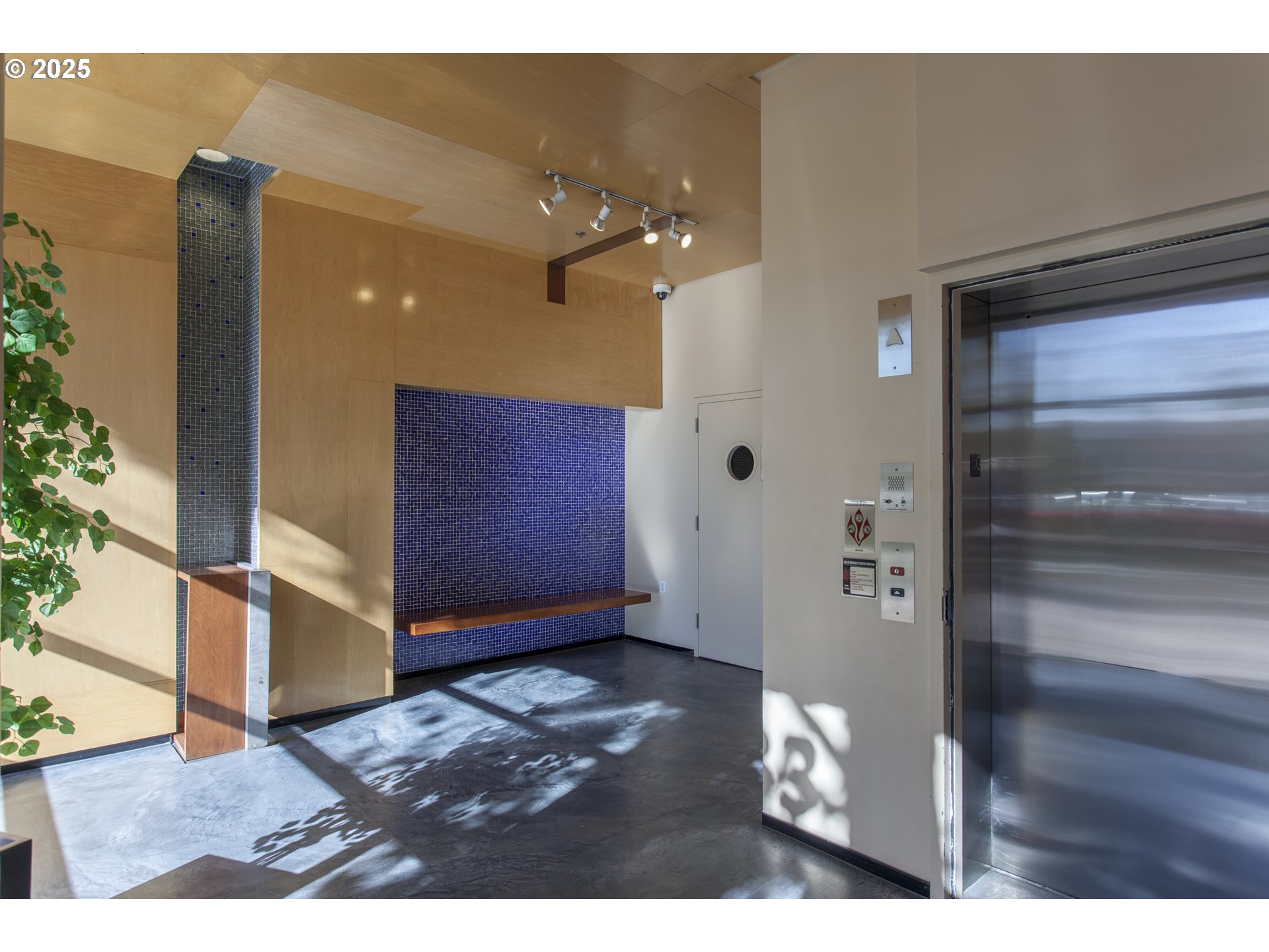 533 Northeast Holladay Street, Unit 308 Portland, OR 97232 - Photo 12 of 16 a view of an empty room with wooden floor and a window