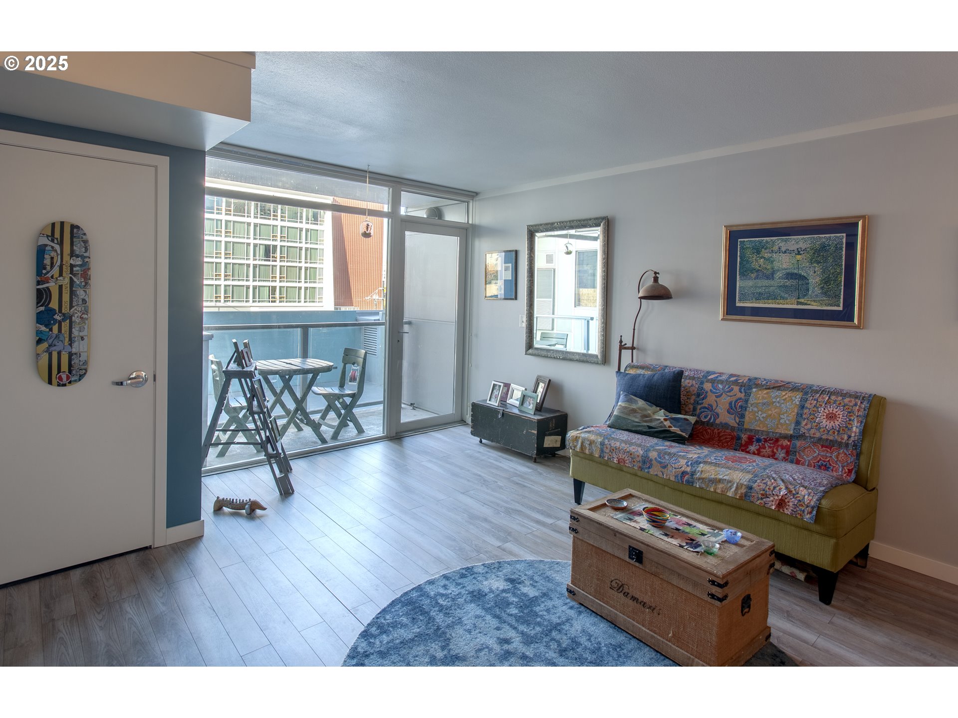 533 Northeast Holladay Street, Unit 308 Portland, OR 97232 - Photo 4 of 16 a living room with furniture and wooden floor