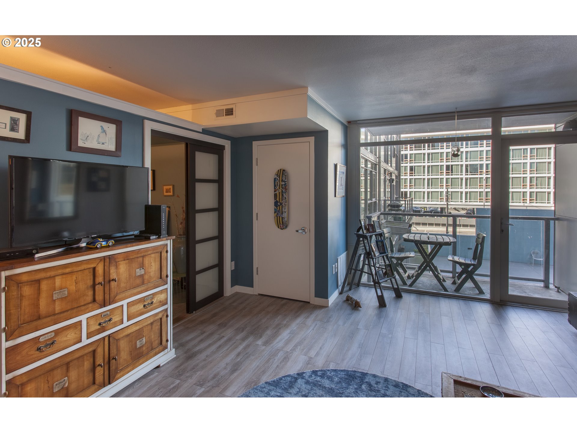 533 Northeast Holladay Street, Unit 308 Portland, OR 97232 - Photo 5 of 16 a living room with furniture and a flat screen tv