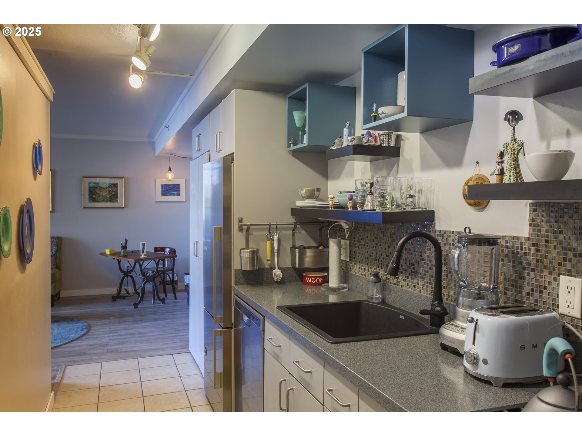 533 Northeast Holladay Street, Unit 308 Portland, OR 97232 - Photo 7 of 16 a kitchen with a sink and a stove top oven