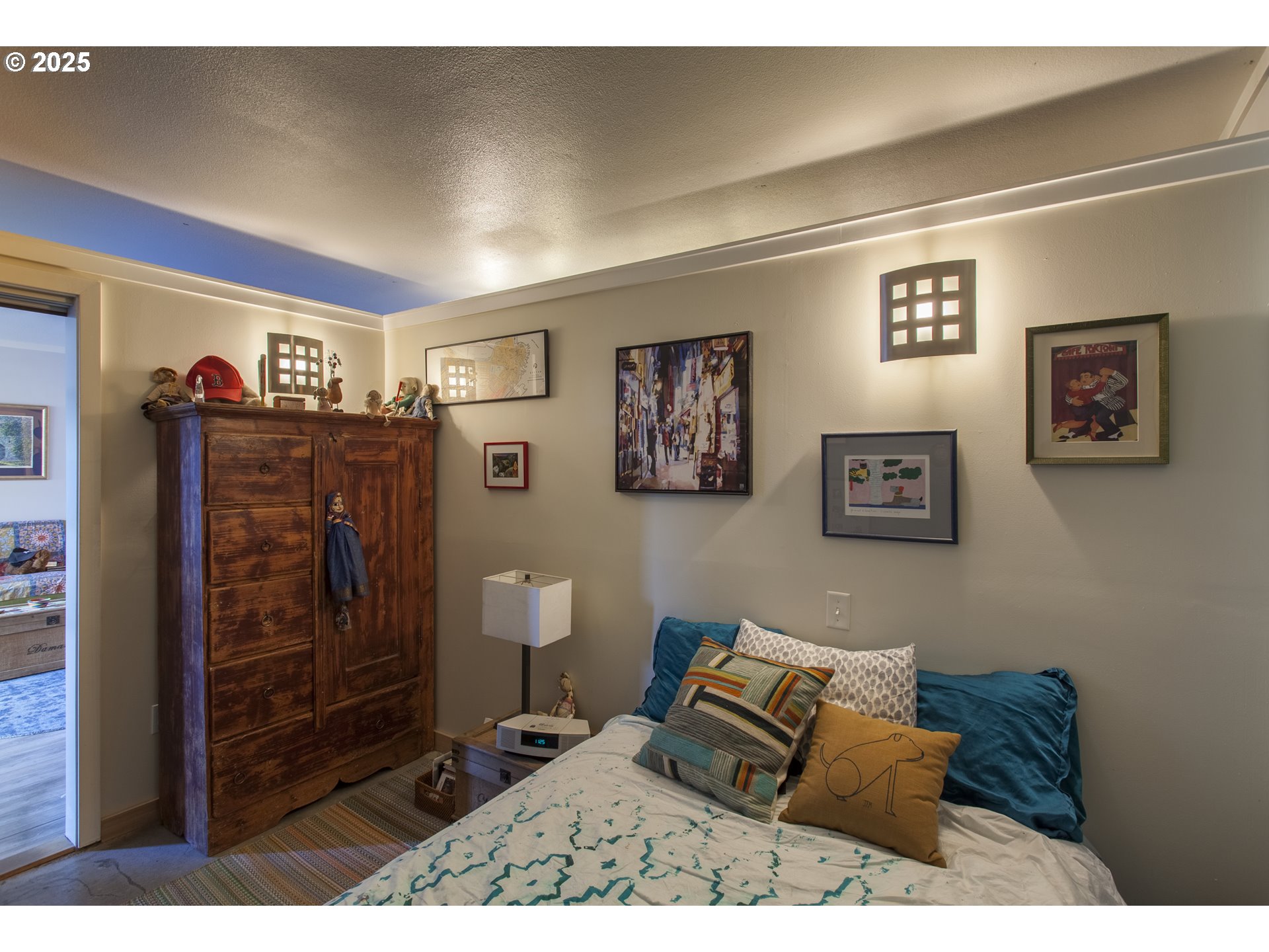 533 Northeast Holladay Street, Unit 308 Portland, OR 97232 - Photo 8 of 16 a bedroom with a bed and a walk in closet