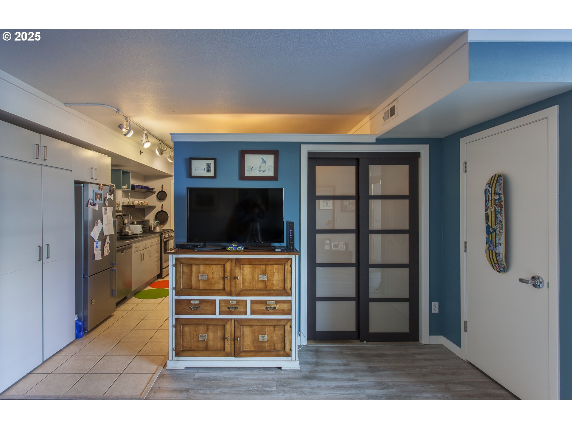 533 Northeast Holladay Street, Unit 308 Portland, OR 97232 - Photo 10 of 16 a living room with furniture and a flat screen tv