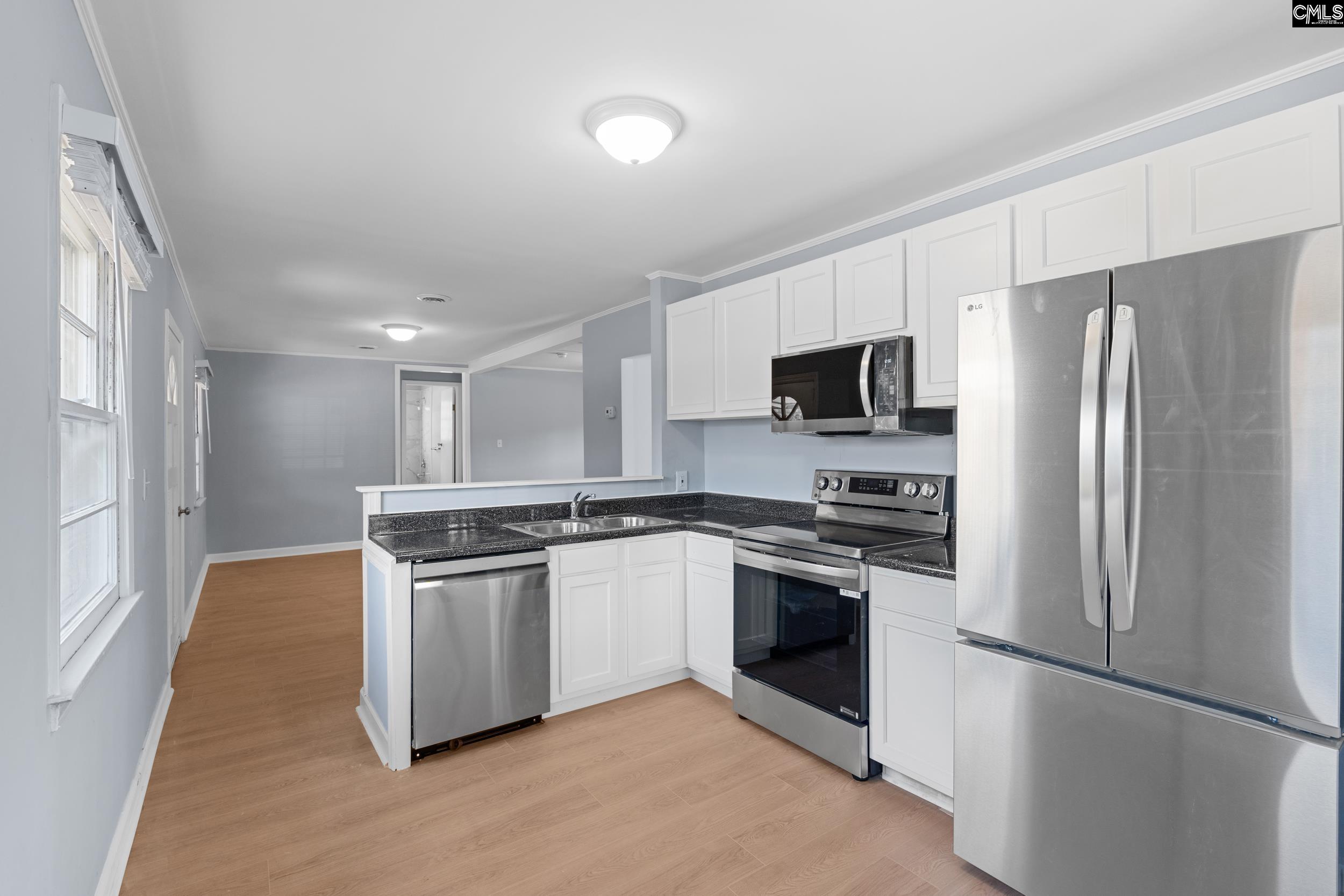 409 Wilkes Road Columbia, SC 29203 - Photo 12 of 34 a kitchen with stainless steel appliances granite countertop a refrigerator stove a sink and dishwasher