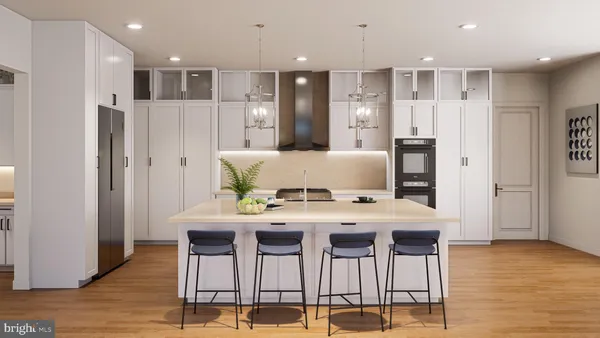 a kitchen with stainless steel appliances kitchen island granite countertop a refrigerator and a stove top oven