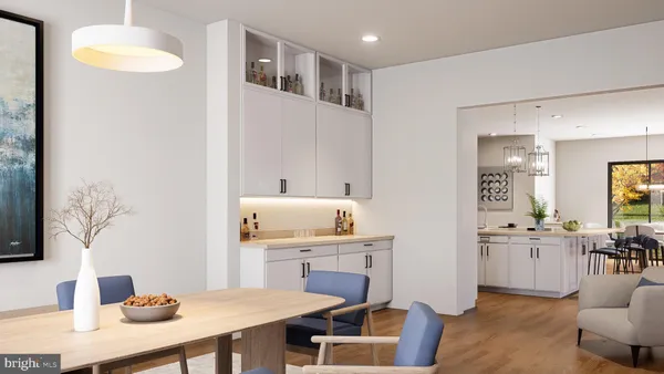 a kitchen with a table chairs sink and cabinets