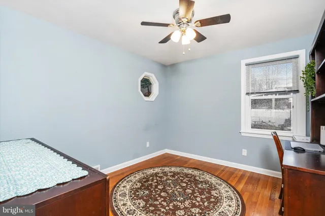 a view of a bedroom with a bed and a window