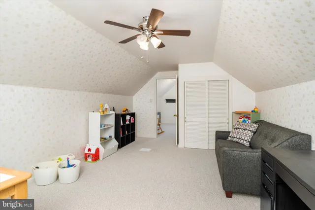 a room with furniture and ceiling fan