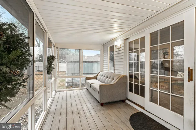 a spacious bedroom with a large window and a balcony