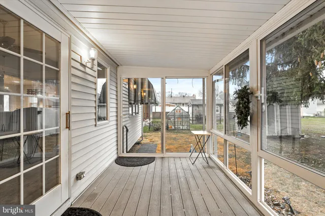 a view of a balcony with wooden floor and floor to ceiling windows with wooden floor