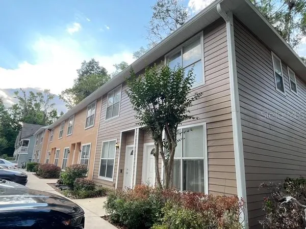 a front view of a house with trees