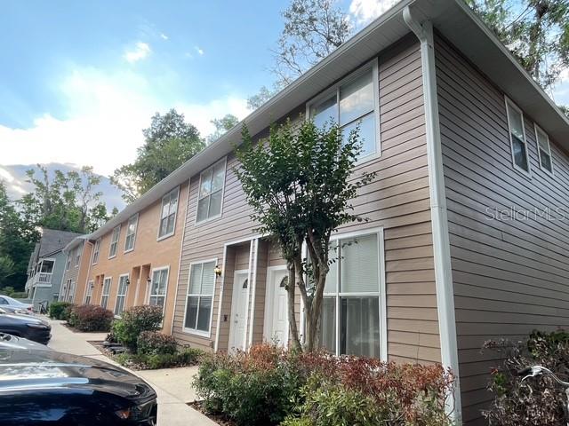 4415 Southwest 34th Street, Unit 708 Gainesville, FL 32608 - Photo 1 of 9 a front view of a house with trees