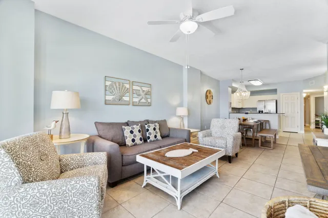 a living room with furniture a table and a lamp