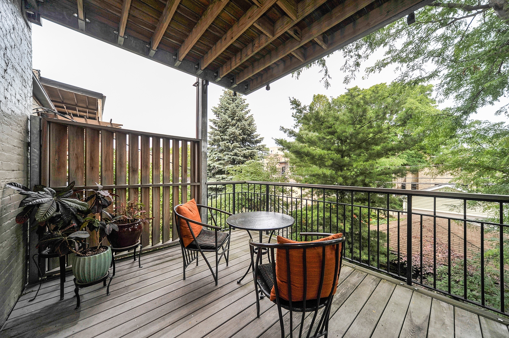 3729 North Wayne Avenue, Unit 2 Chicago, IL 60613 - Photo 12 of 12 a balcony with wooden floor table and chairs