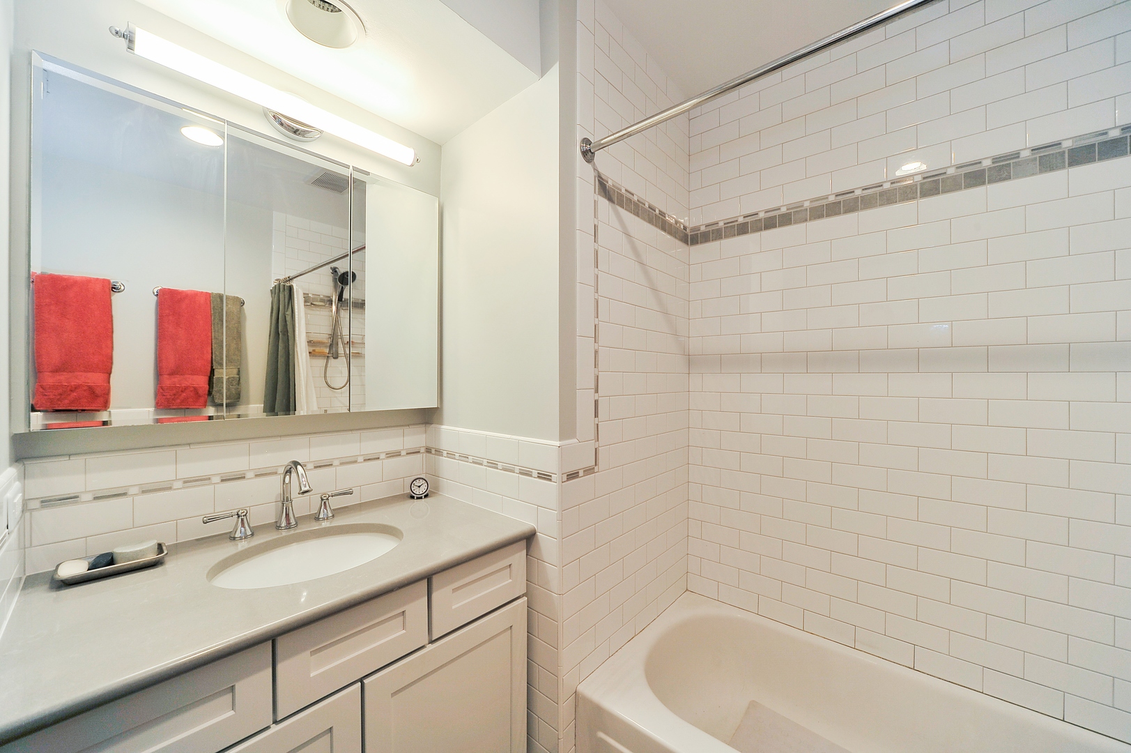 3729 North Wayne Avenue, Unit 2 Chicago, IL 60613 - Photo 10 of 12 a bathroom with a granite countertop sink and a bathtub