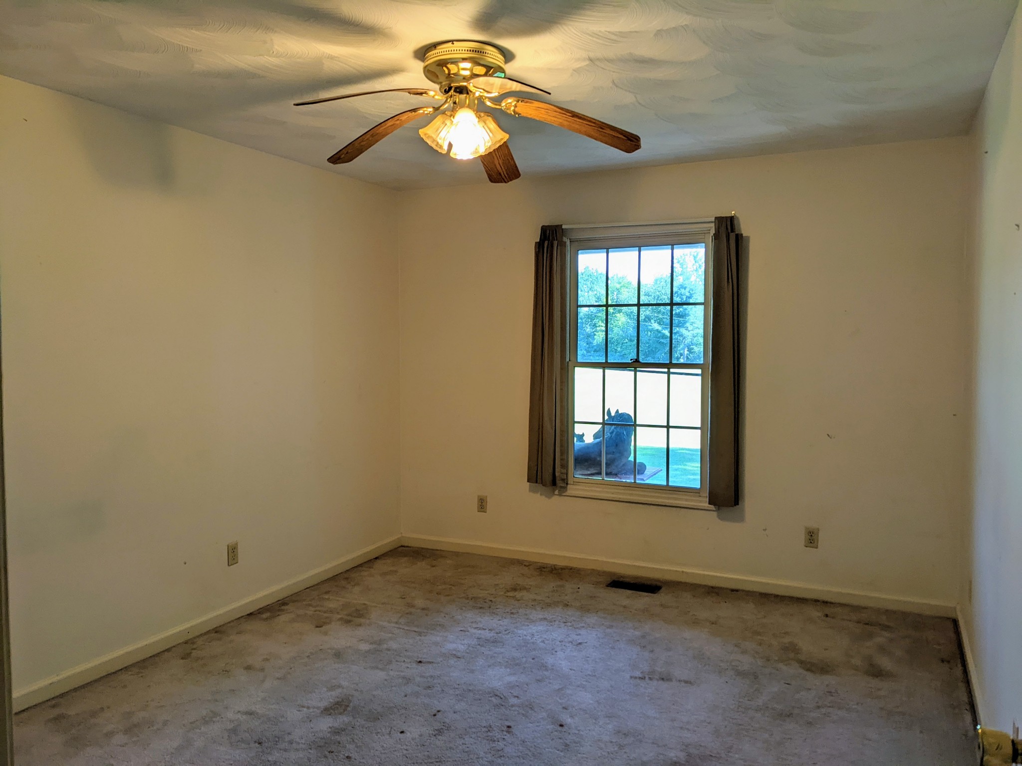 1843 Sainville Road Manchester, TN 37355 - Photo 31 of 32 an empty room with a window and a fan