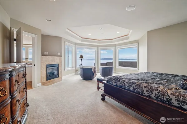 a spacious bedroom with bed and a fireplace
