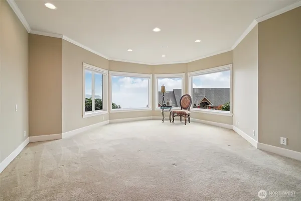 a view of a livingroom with a flat screen tv a dinning table and chairs in a room