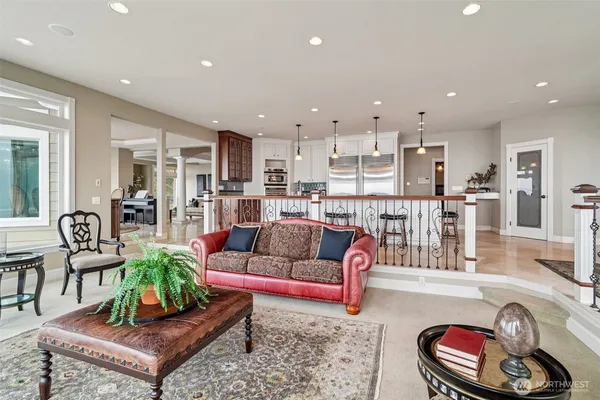 a living room with furniture and a view of kitchen