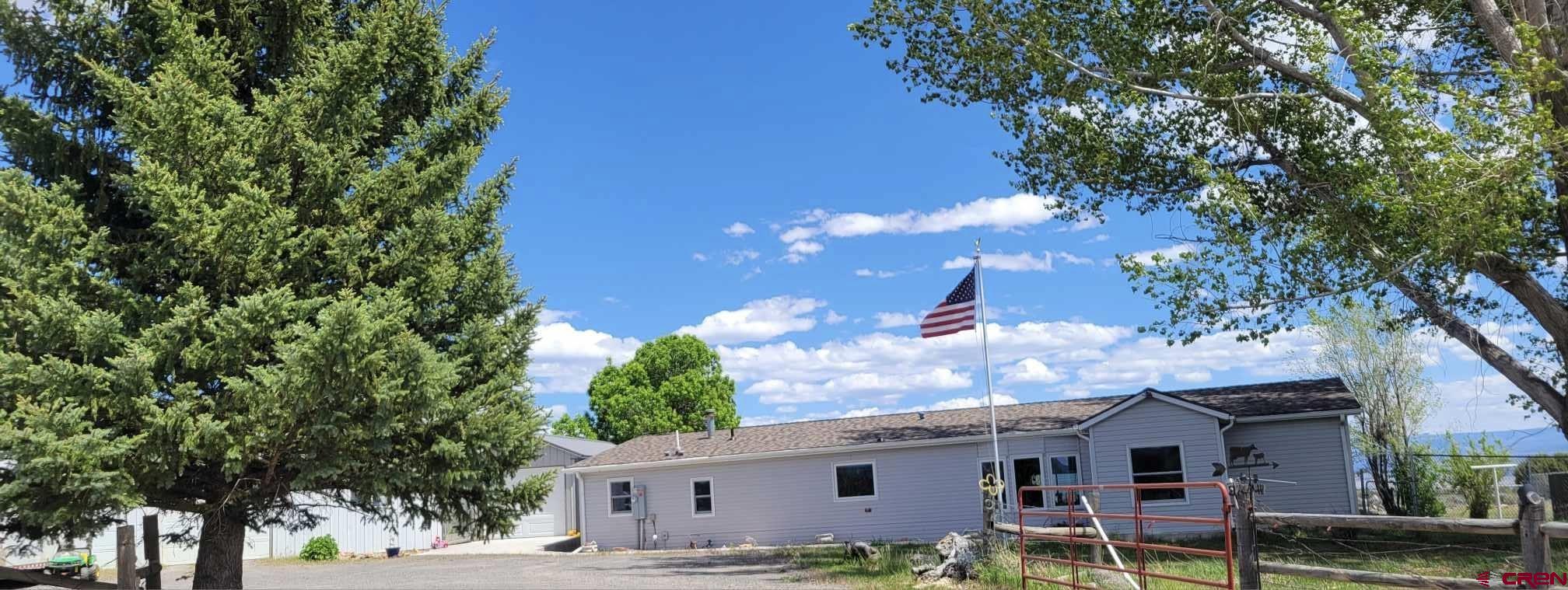 12880 2900th Road Hotchkiss, CO 81419 - Photo 16 of 22 a front view of a house with garden