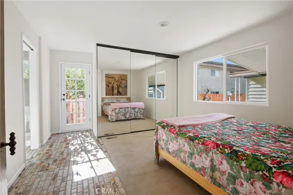 a bedroom with double bed and a window