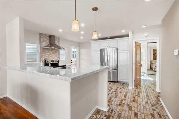 a kitchen with stainless steel appliances a refrigerator and a sink