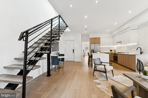 a living room with furniture and a mirror