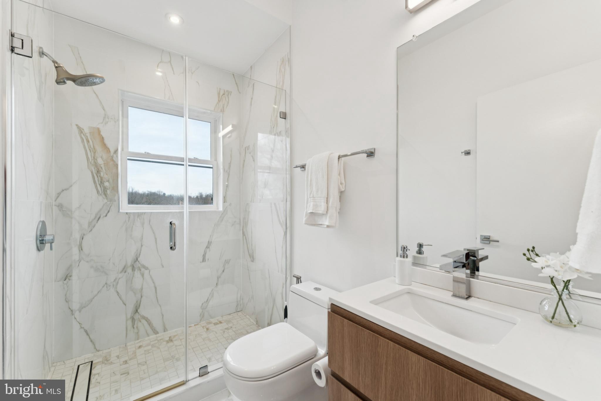 4017 Davis Place Northwest, Unit 7 Washington, DC 20007 - Photo 19 of 39 a bathroom with a sink toilet and shower